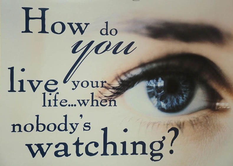 Classroom poster asking How do you live your life when nobody’s watching, with a close photograph of an eye.