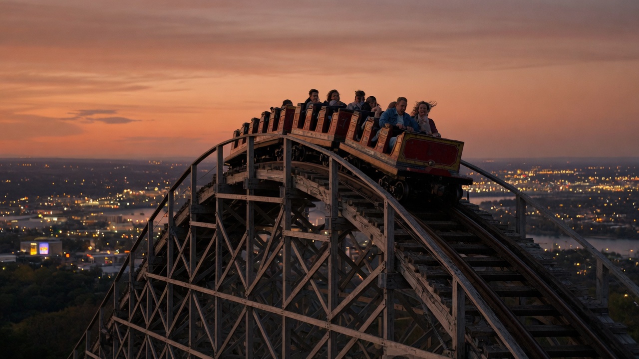 A roller coaster pausing at the top of a hill